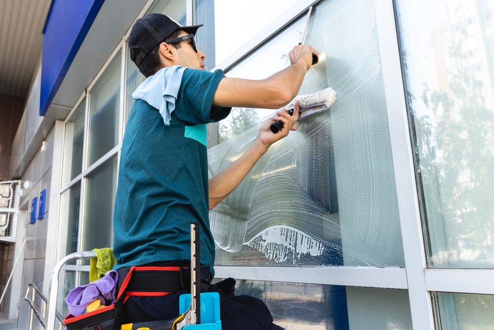 hired cleaner cleans commerical windows