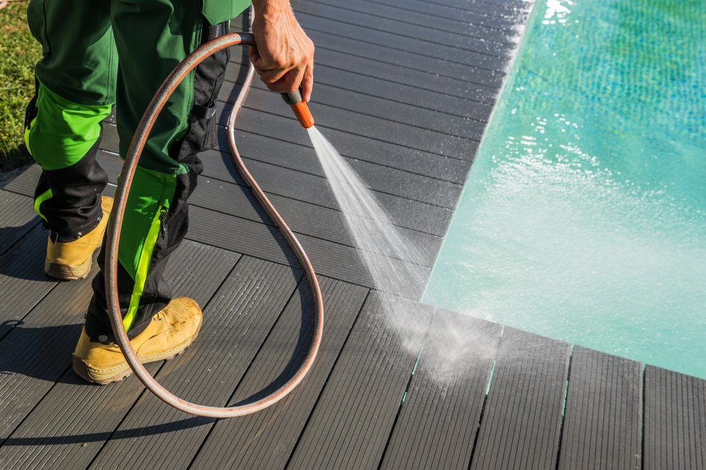 Garden,Maintenance,Worker,Washing,The,Timber,Decking,Around,Residential,Swimming